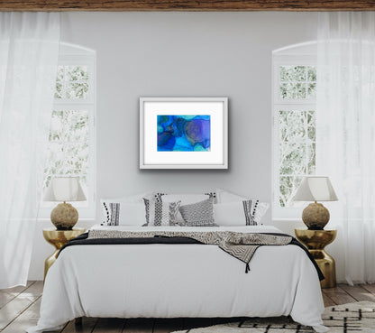 Blue Drift by Ludwina Orchard – alcohol ink painting on polypropylene displayed in a bohemian-style bedroom with white bedding, patterned pillows and gold side tables