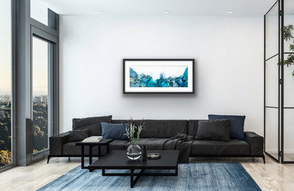 Blue Ocean by Ludwina Orchard – alcohol ink painting displayed in a modern living room with dark sectional sofa and city view