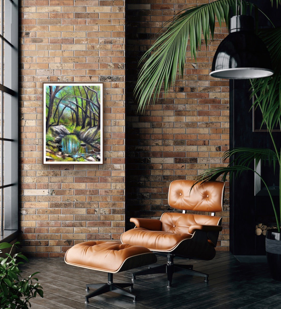 Everglades by Ludwina Orchard – framed soft pastel forest painting on an exposed brick wall in an industrial-style room with a leather lounge chair and tropical plants