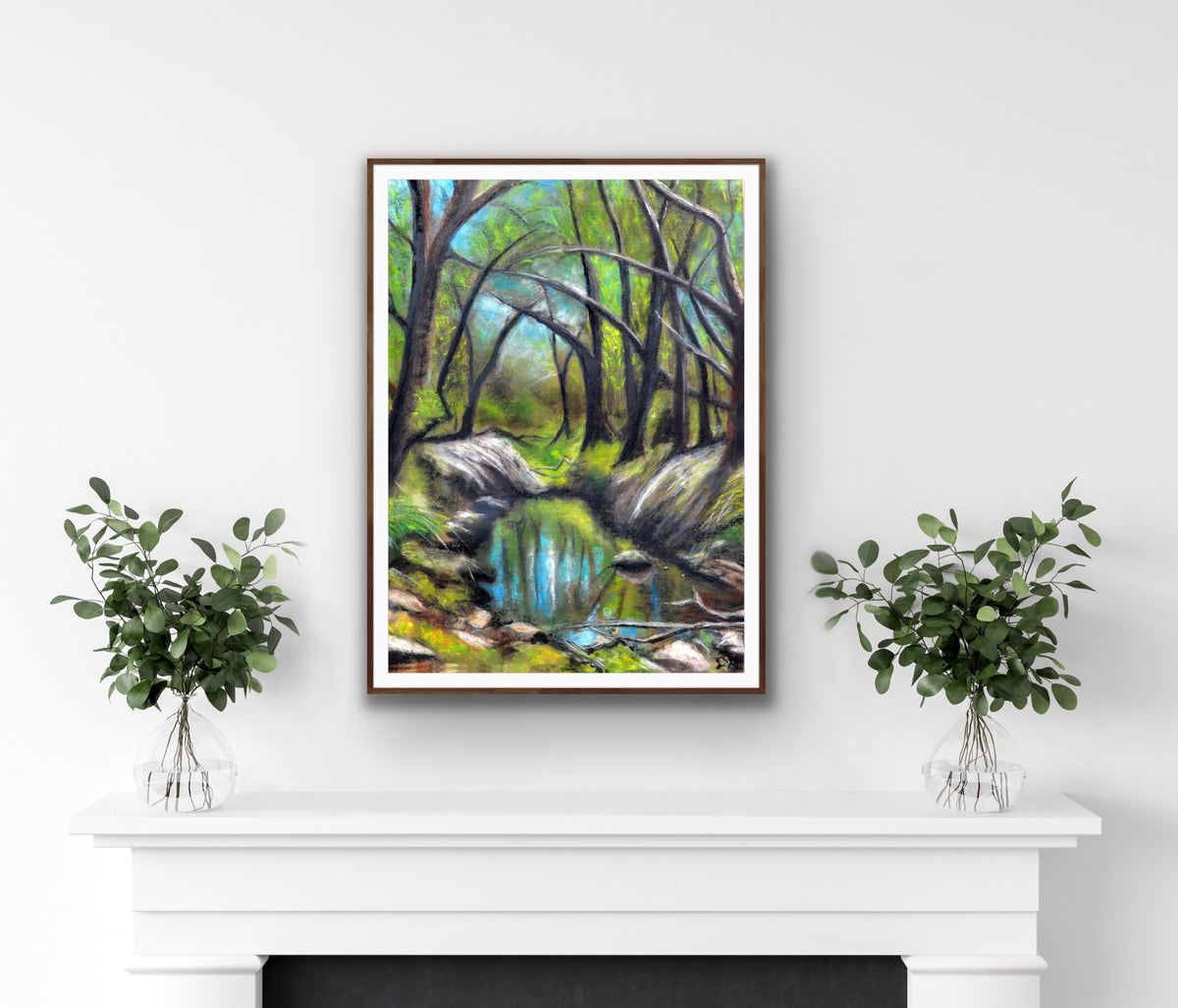 Everglades by Ludwina Orchard – framed soft pastel forest painting displayed on a white mantelpiece with eucalyptus plant arrangements on either side