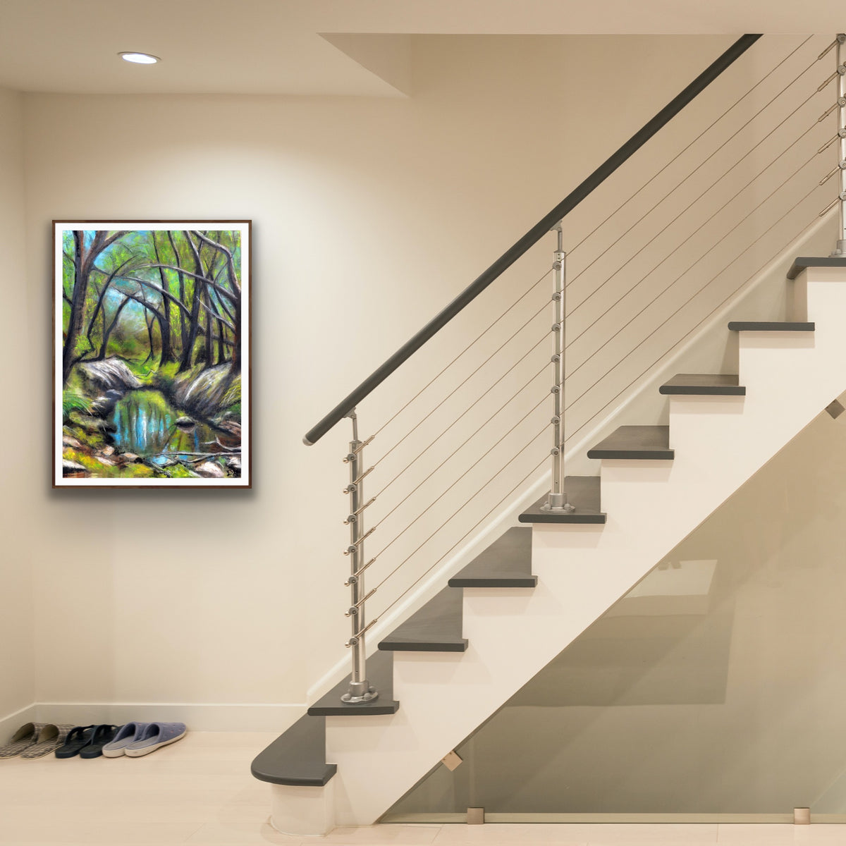 Everglades by Ludwina Orchard – framed soft pastel forest painting displayed on a wall at the foot of a modern staircase with cable railings
