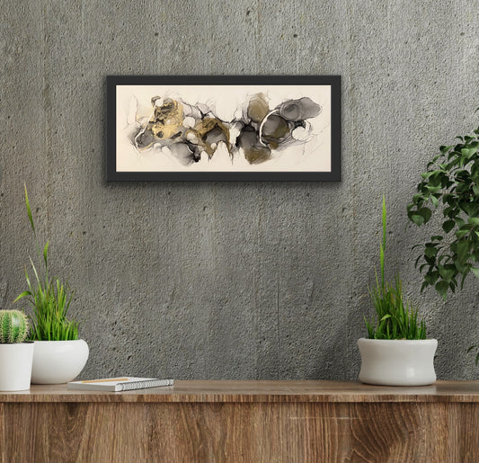 Golden Dreams by Ludwina Orchard – alcohol ink painting displayed above a wooden sideboard with potted plants against a grey concrete wall