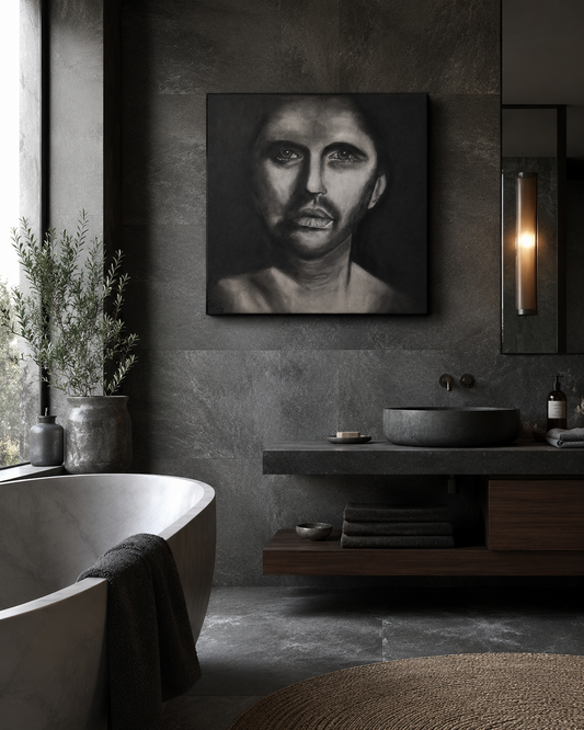 The Man Within by Ludwina Orchard – charcoal portrait displayed in a dark moody bathroom with dark stone walls and a freestanding bathtub