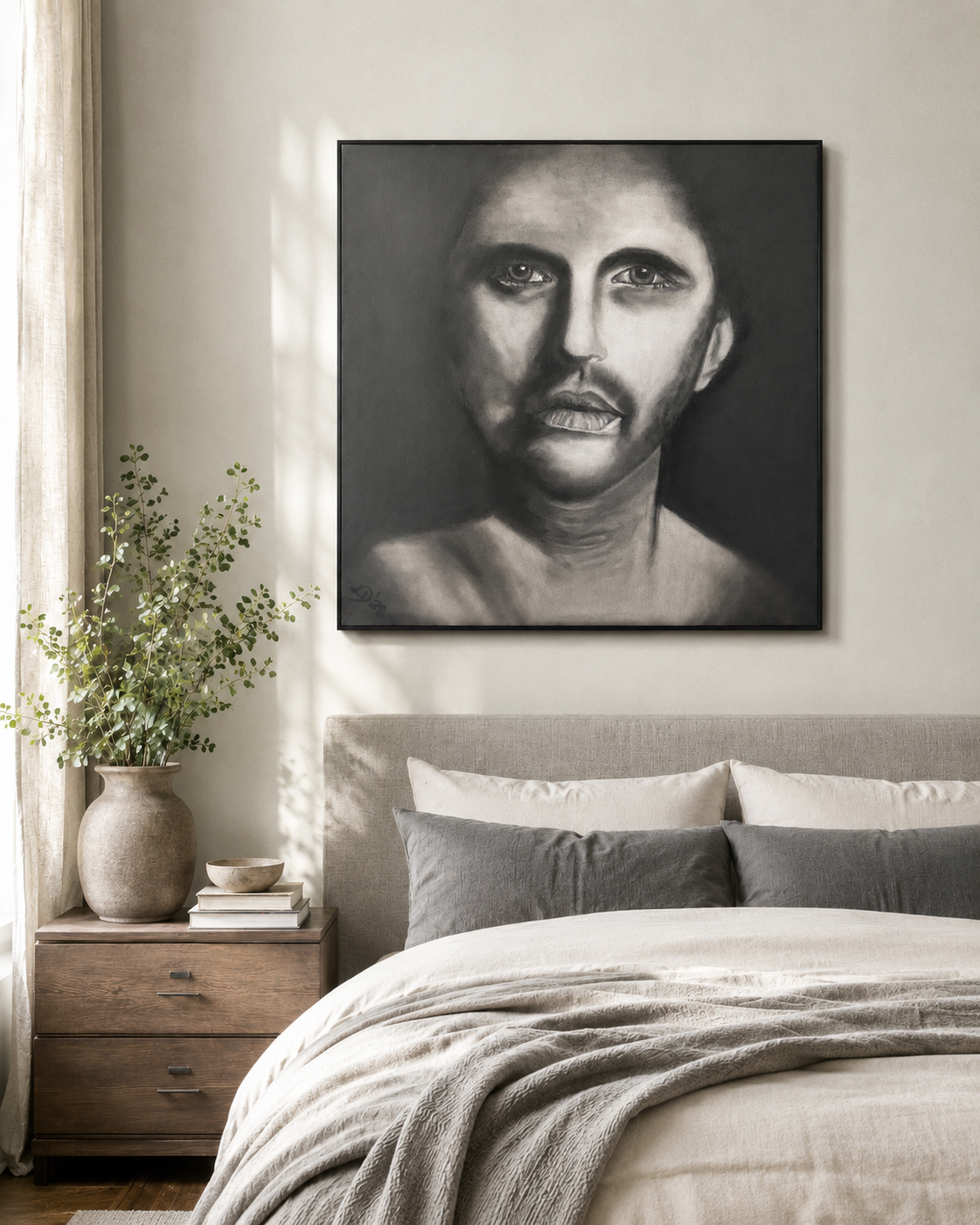 The Man Within by Ludwina Orchard – charcoal portrait displayed above a bed in a neutral bedroom with wooden nightstand and greenery