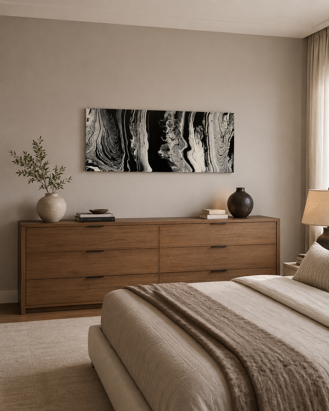 Wisdom by Ludwina Orchard – ring-poured acrylic painting displayed above a wooden dresser in a neutral beige bedroom