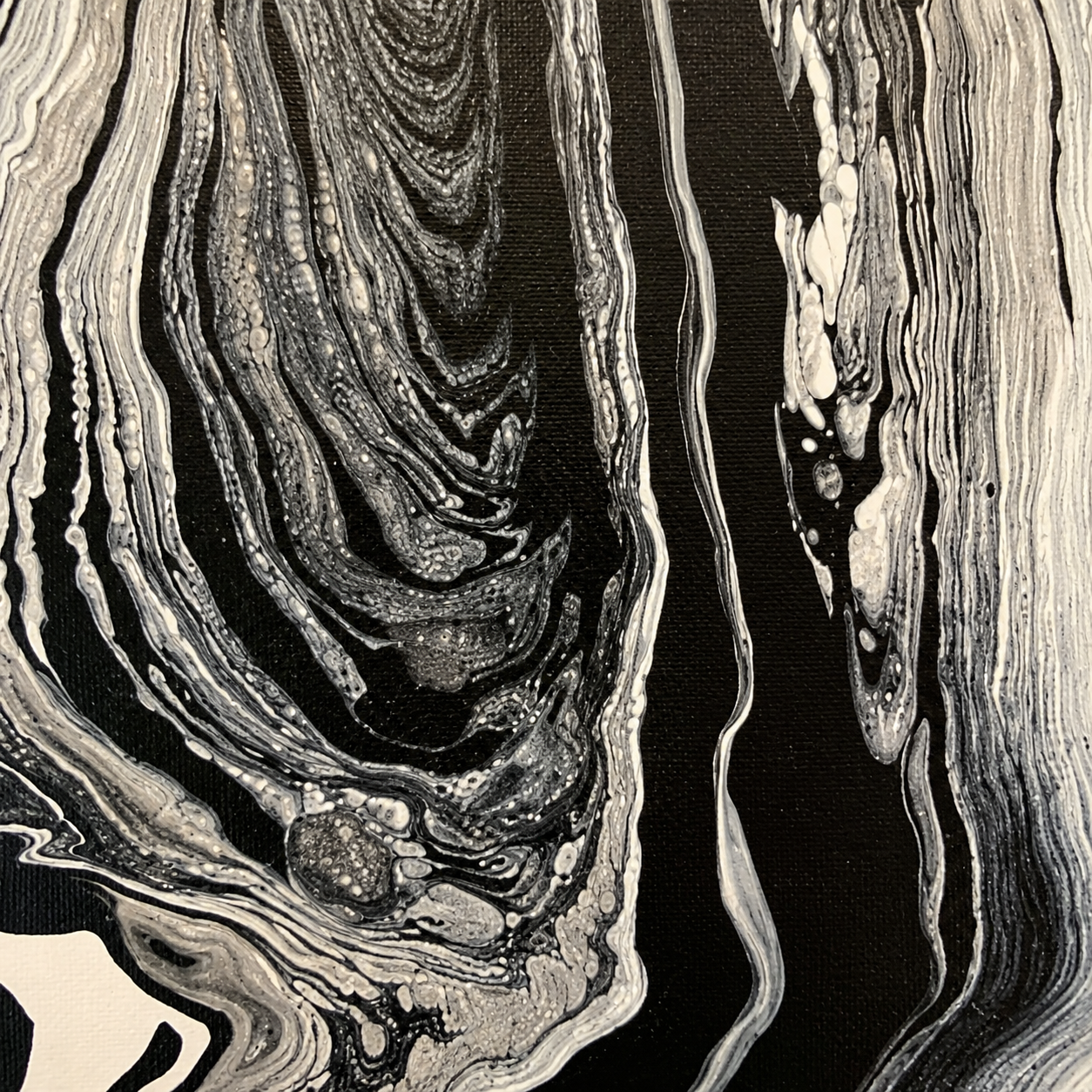 Wisdom by Ludwina Orchard – close-up detail of the ring-poured acrylic painting showing swirling black and white organic patterns