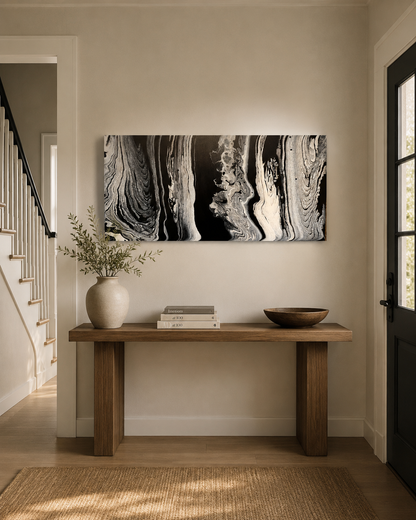 Wisdom by Ludwina Orchard – ring-poured acrylic painting with black, white and grey swirling forms displayed above a wooden console table in an entryway